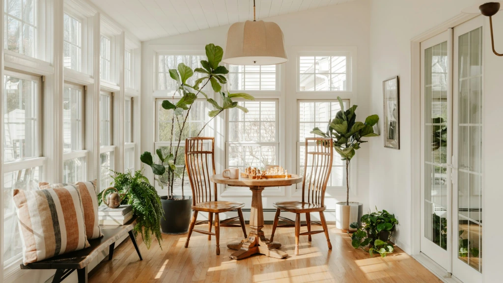 Bright sunroom with plants and dining table